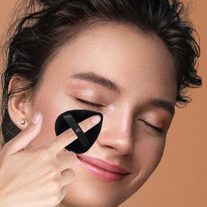 Woman applying powder with Velvet Powder Puff Duo for smooth, poreless skin.