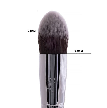 Close-up of Nanshy Conceal Perfector brush with pointed, soft rounded tip measuring 34mm in length and 23mm in width, featuring shiny silver handle and densely packed bristles for precise makeup application.