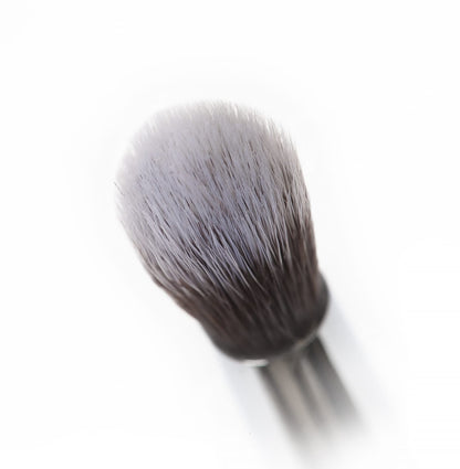 Close-up of Nanshy's Eye Crease makeup brush with soft, antibacterial synthetic bristles and a pearl-coated handle.