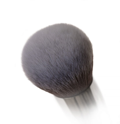 Close-up image of the Buffed Base makeup brush with soft, fluffy bristles perfect for achieving a flawless foundation finish.