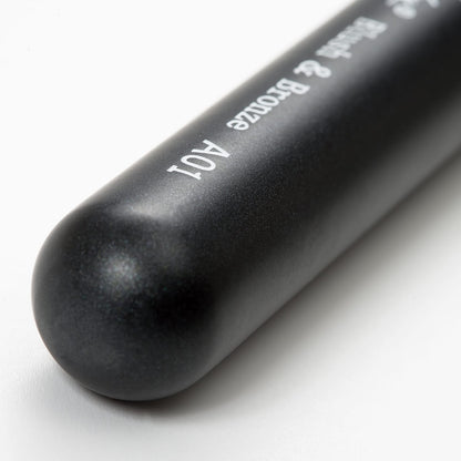 Close-up of the "Buffed Base" makeup brush handle with sleek black design and white text, showcasing the ergonomic grip.